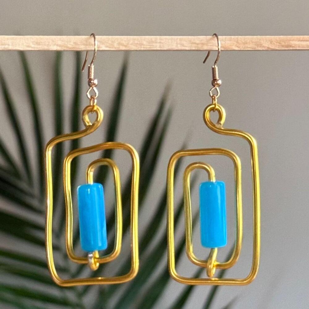 handmade gold wire spiral earrings with cerulean blue colored tube beads